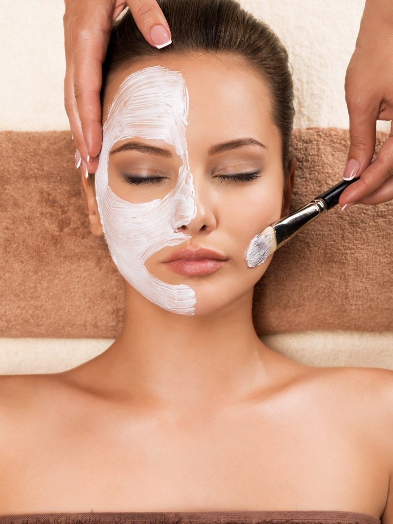 Facial Woman having a facial cosmetic mask at spa salon.